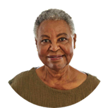 Woman with grey hair smiling, wearing a brown shirt